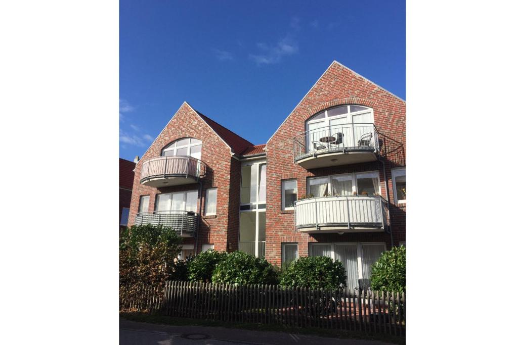 a brick building with balconies on the side of it at Atlantik-Kolk 30 in Norddeich