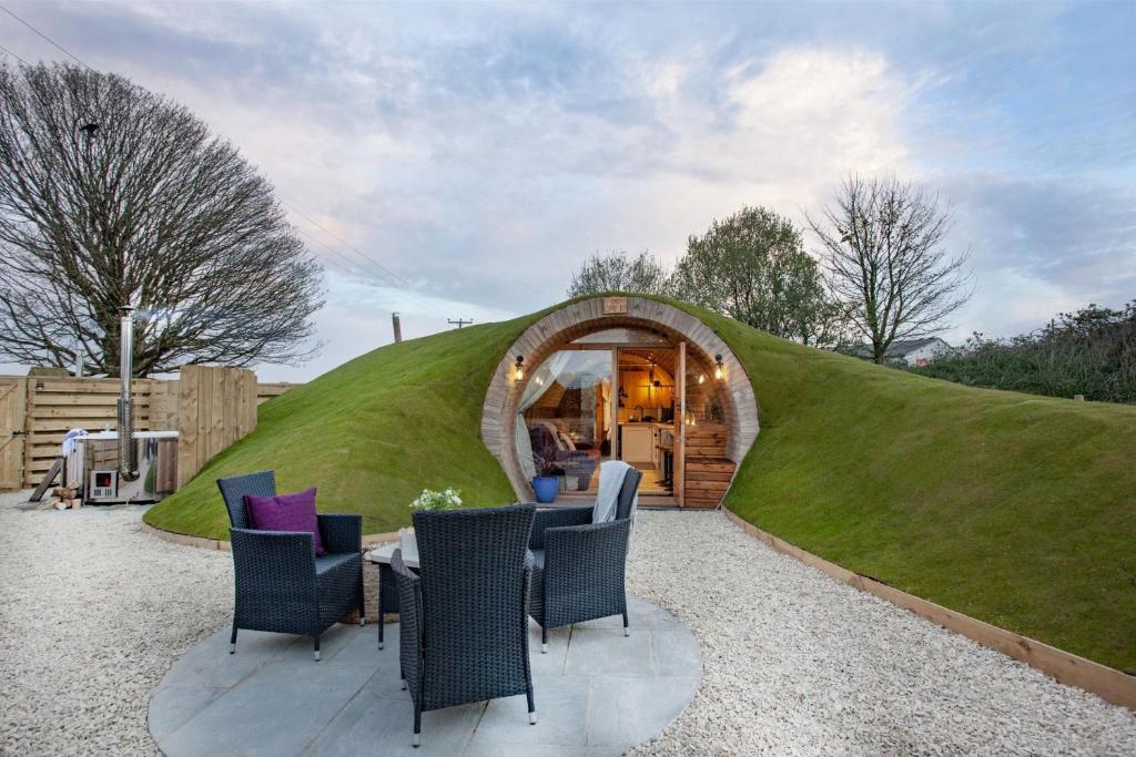 a grass dome home with a table and chairs at The Charm Inn, The Little Burrow, Nr Wells in Radstock