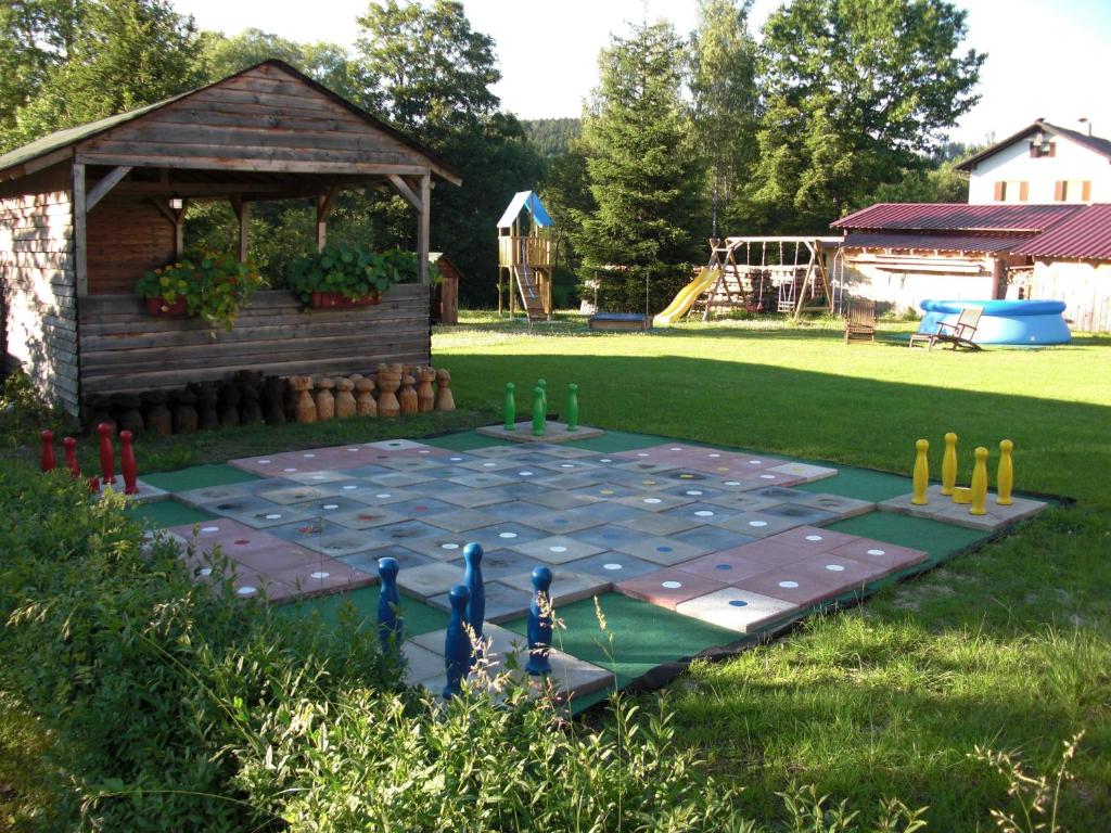 a game table in a yard with a gazebo at Pension Wiesenau in Bayerisch Eisenstein