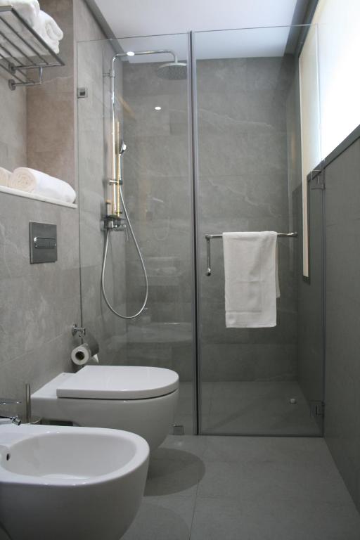 a bathroom with a shower and a toilet and a sink at Valley Boutique Hotel in Safi