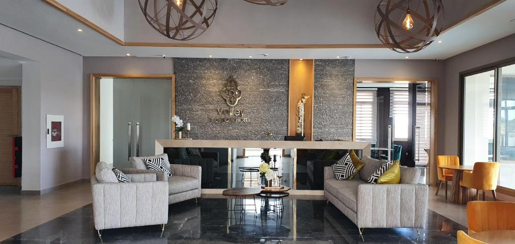 a living room with two couches and a fireplace at Valley Boutique Hotel in Safi