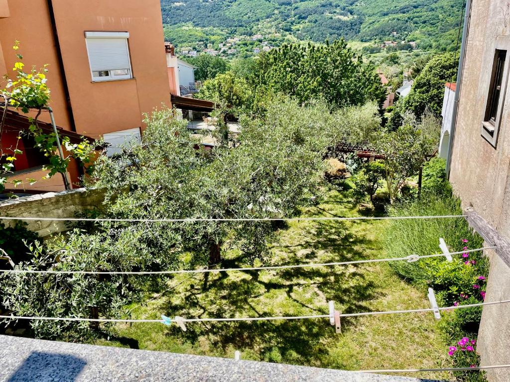 a view of a garden from a balcony of a building at Apartments Rome in Baška