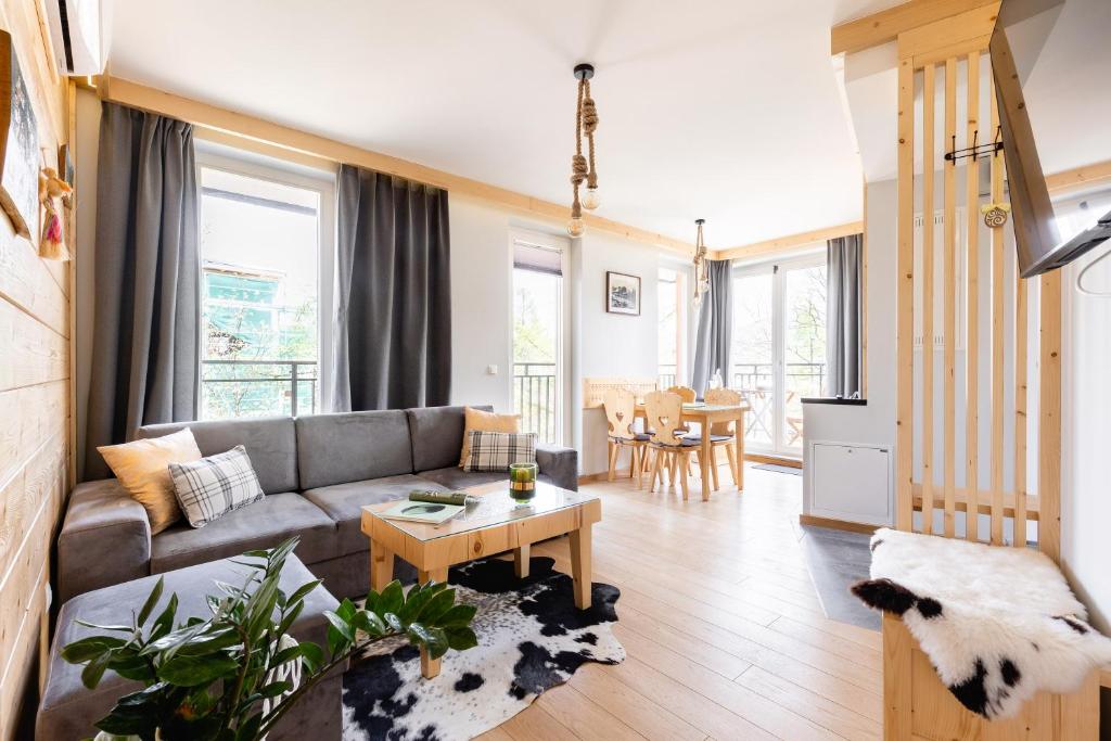 a living room with a couch and a table at Villa Monte Zakopane in Zakopane
