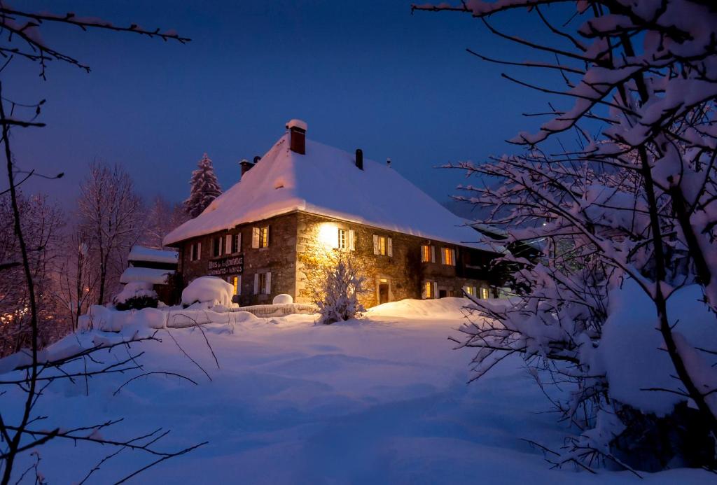 a house covered in snow at night at Hotel Mas de la Coutettaz, The Farmhouse in Morzine