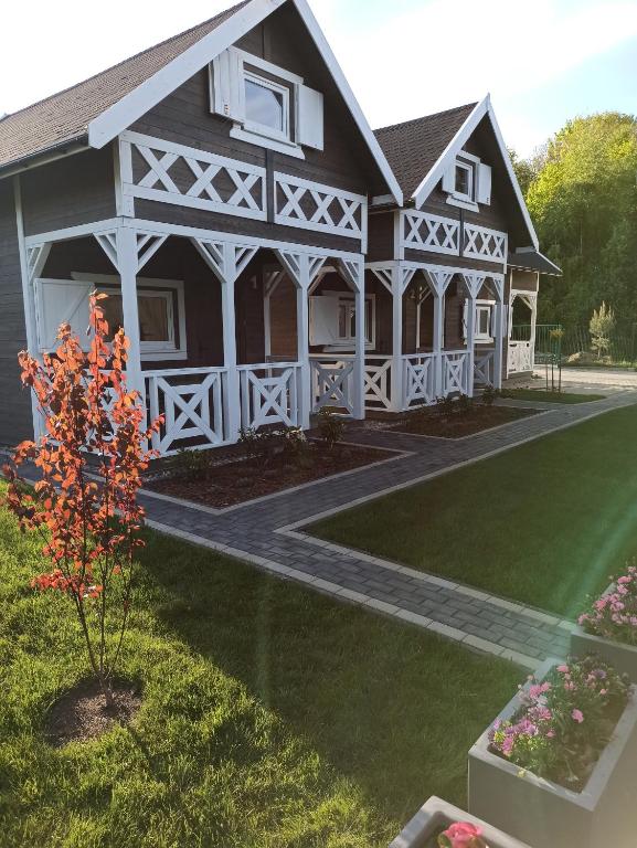 a rendering of a large house with a porch at Domkoland in Dziwnówek
