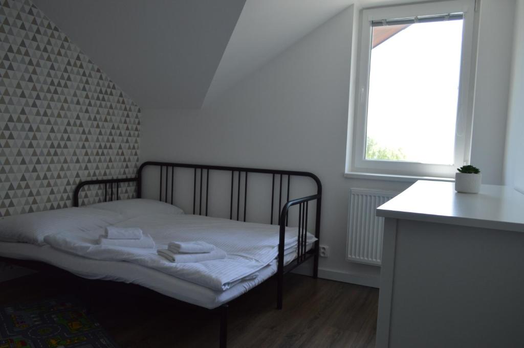 A bed or beds in a room at Ager Apartments