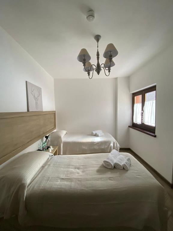 Łóżko lub łóżka w pokoju w obiekcie HOTEL CAMPO STELLA