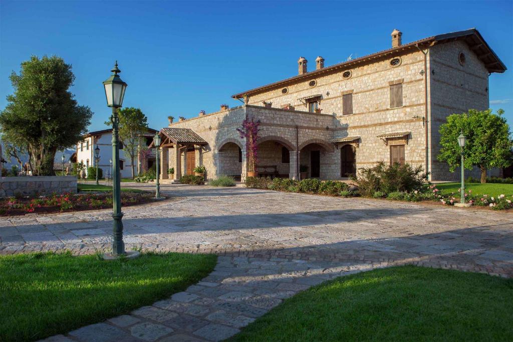 a large brick building with a street light in front of it at Tenuta Vento di Mare in Lido Di Fondi