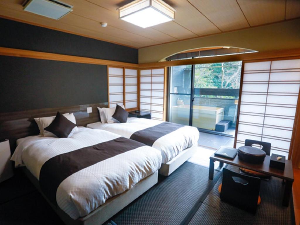 A bed or beds in a room at LiVEMAX RESORT Okudogo