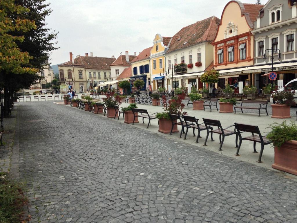 una calle adoquinada con bancos y edificios en Vár-Lak, en Kőszeg