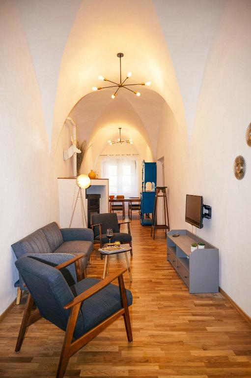 a living room with a couch and a table at Franz Haus Apartments in Merano