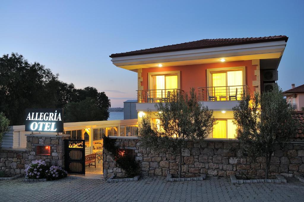 a building with a sign in front of it at Allegria Butik Otel in Ildır