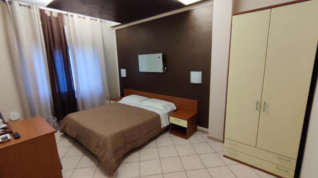 Postel nebo postele na pokoji v ubytování Hotel Emiliana