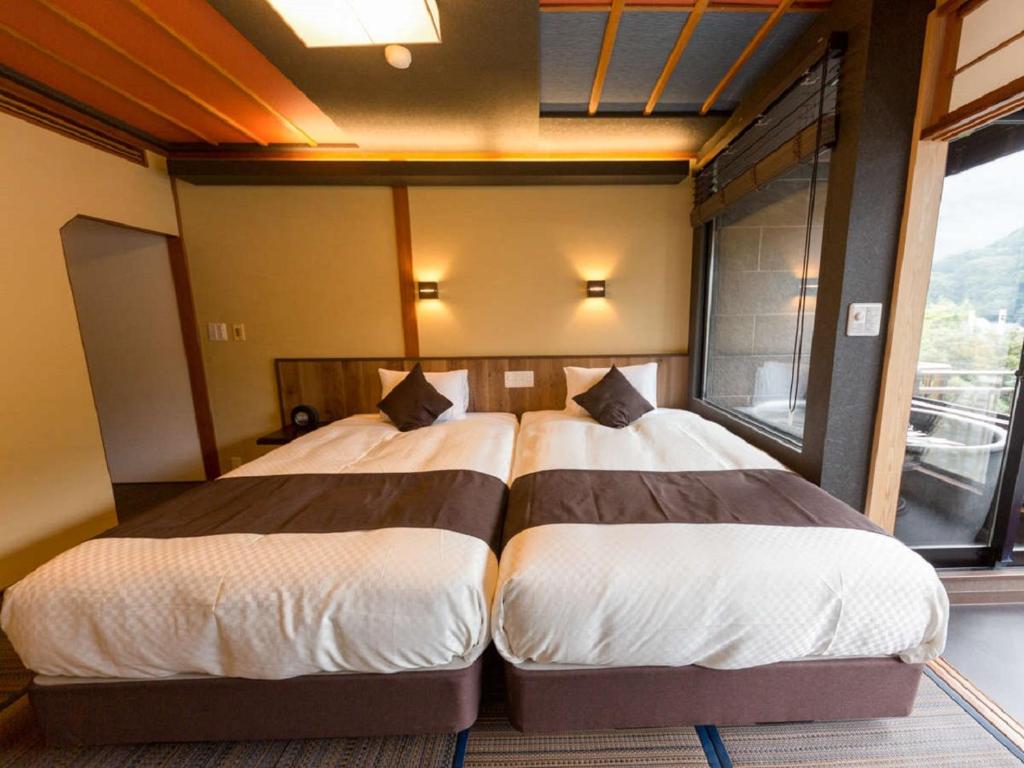 Postel nebo postele na pokoji v ubytování LiVEMAX RESORT Kawaji