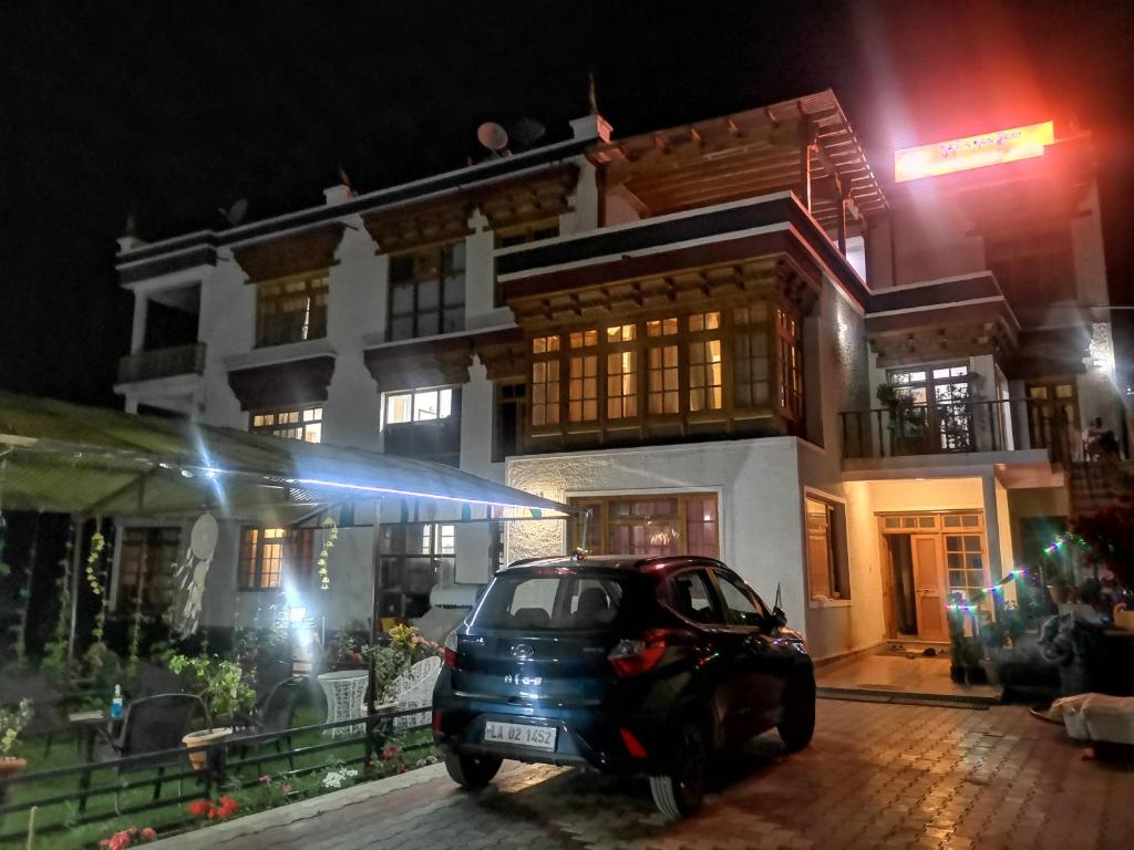 a car parked in front of a building at night at Gangs-Shun Homestay in Leh
