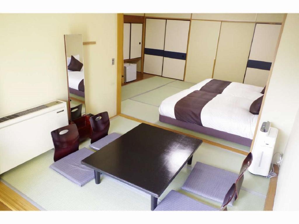 Postel nebo postele na pokoji v ubytování LiVEMAX RESORT Kawaji