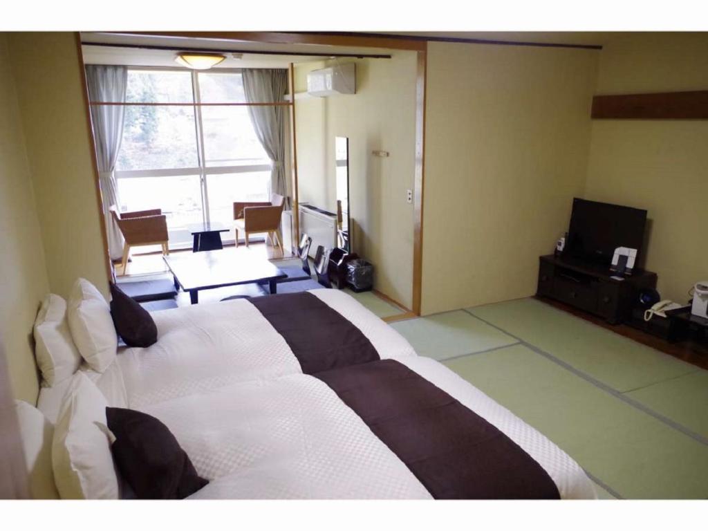 Postel nebo postele na pokoji v ubytování LiVEMAX RESORT Kawaji