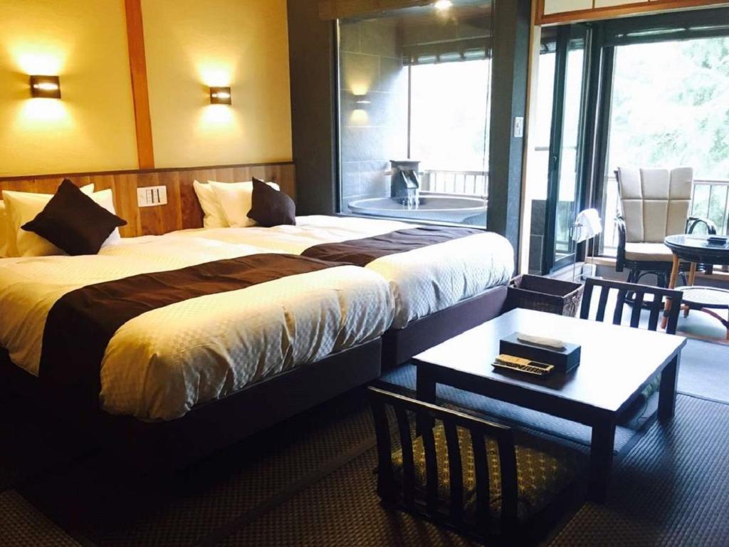 Postel nebo postele na pokoji v ubytování LiVEMAX RESORT Kawaji