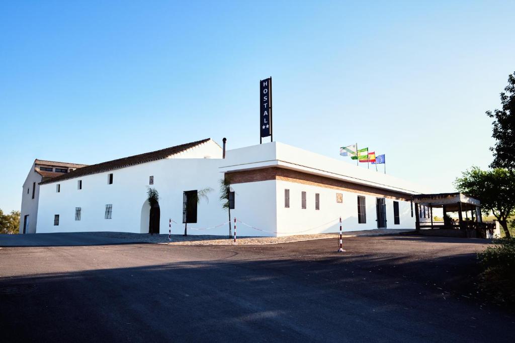 Un bâtiment blanc avec un panneau en haut dans l'établissement El Mirador del Valle, à San Jose del Valle