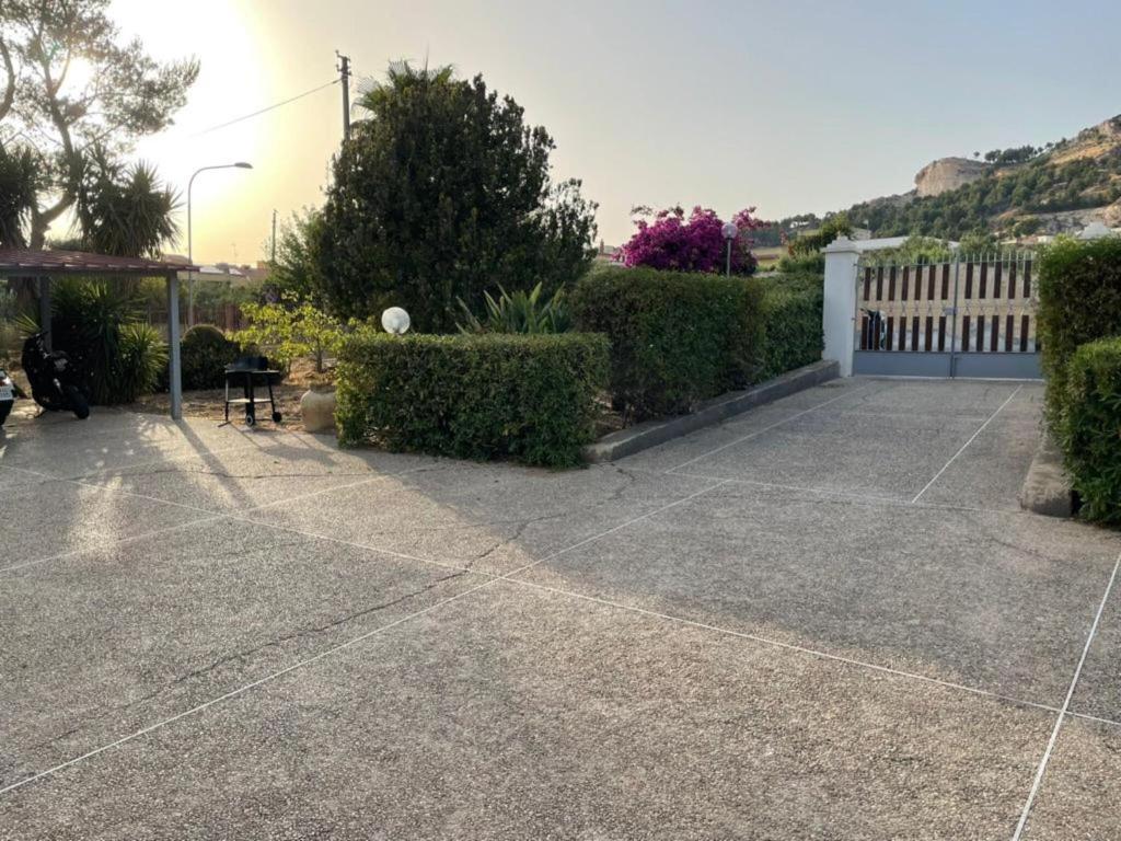 un patio de hormigón con arbustos y una valla blanca en Bilocale a 5 minuti dal mare, en Sciacca