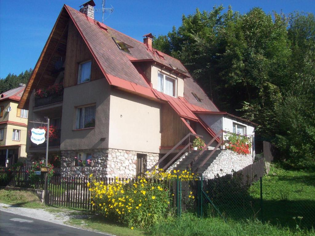 a house with a red roof and a fence at Apartmán - Dagmar in Svoboda nad Úpou