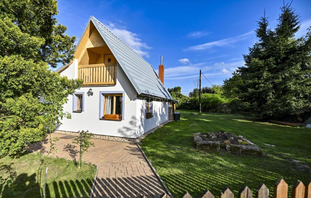 een wit huis met een balkon op een tuin bij Chaloupka Růženka II in Arnoltice u Decina