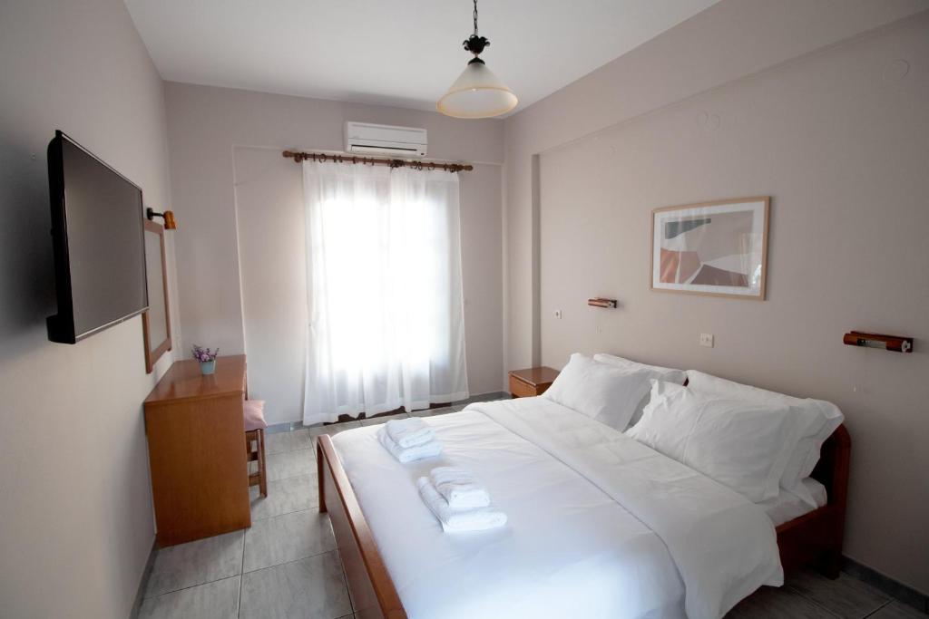 Postel nebo postele na pokoji v ubytování Pomelo Rooms