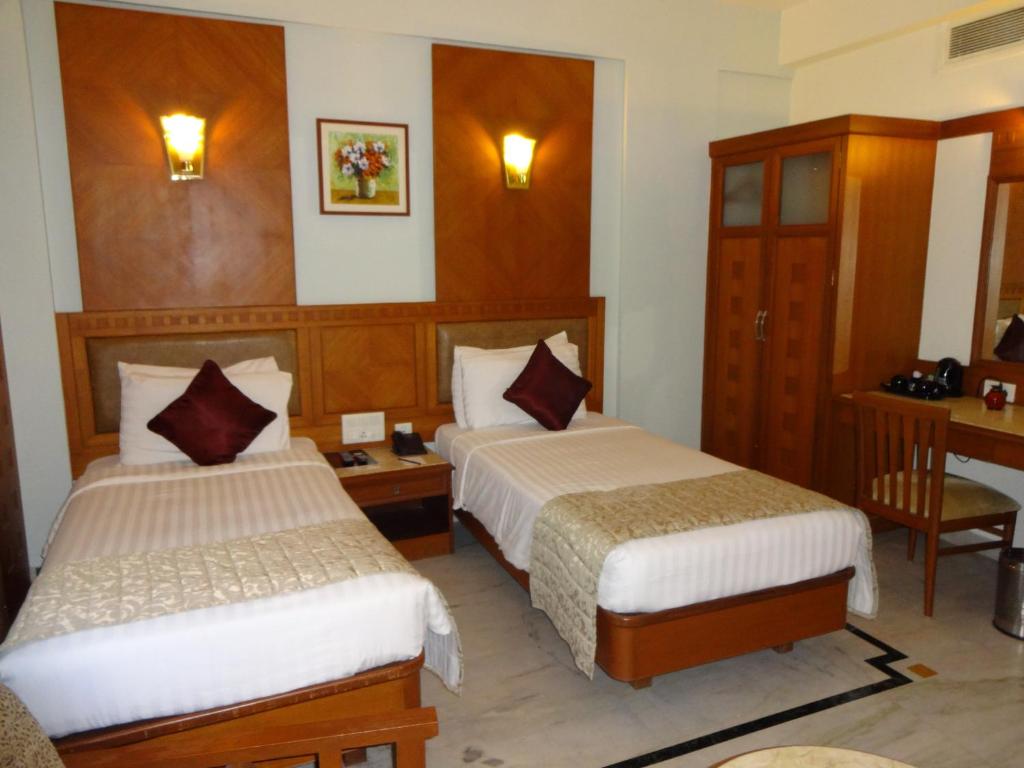 Postel nebo postele na pokoji v ubytování JP Chennai Hotel
