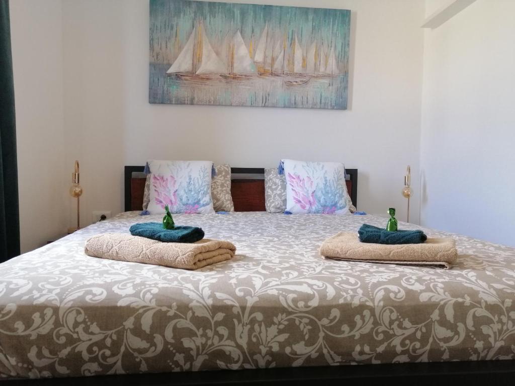 a bedroom with a bed with two pillows on it at Apartment Rita in Mokošica
