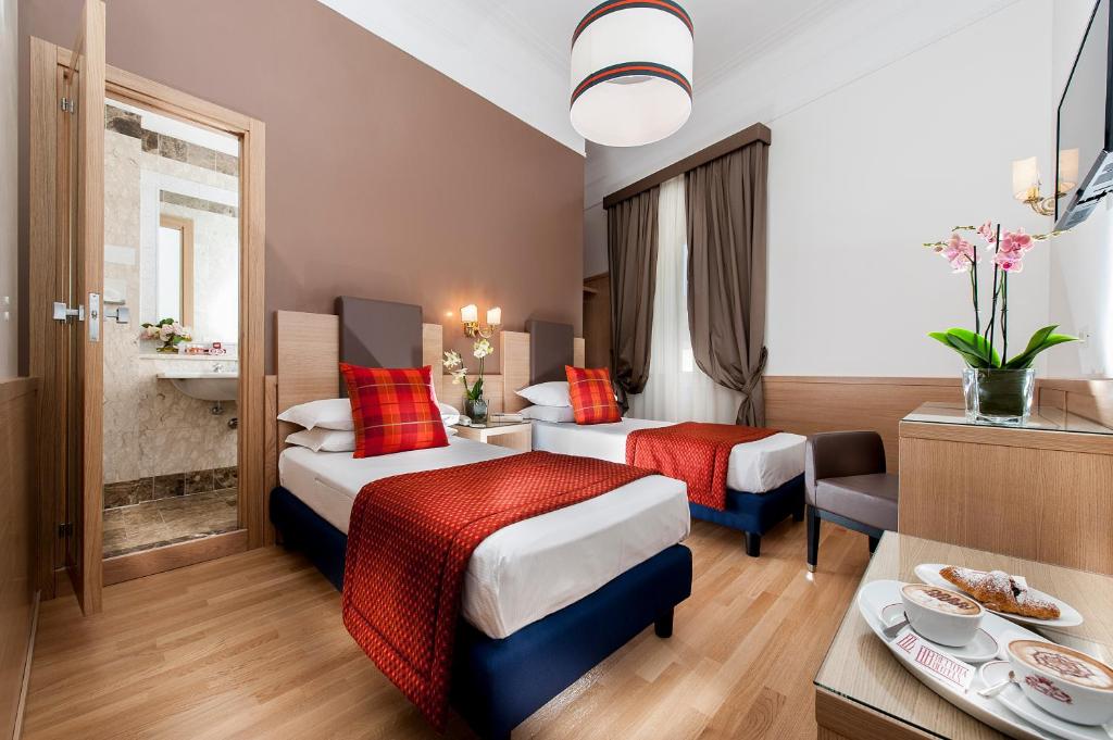 Postel nebo postele na pokoji v ubytování Hotel Nord Nuova Roma