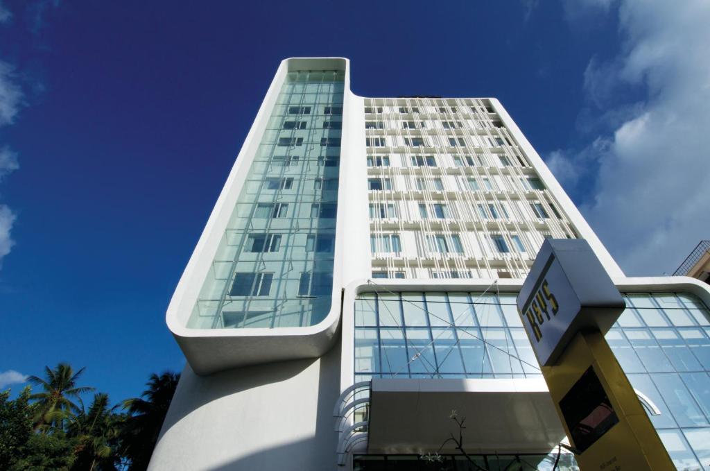 a tall white building with a sign in front of it at Keys Select by Lemon Tree Hotels, Thiruvananthapuram in Trivandrum