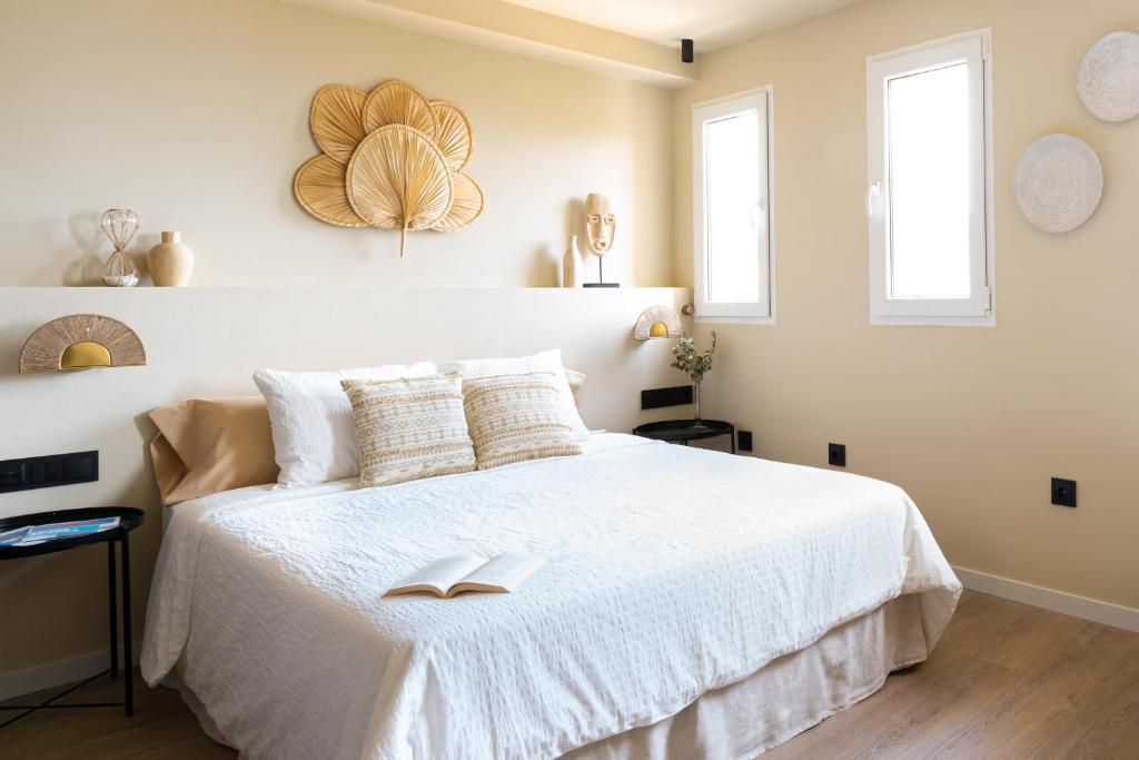 A bed or beds in a room at Jávea Boutique Suites - Holiday Apartments