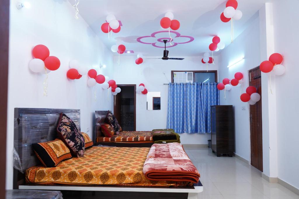 une chambre avec un lit et des ballons rouges au plafond dans l'établissement Roop Niwas, à Amritsar