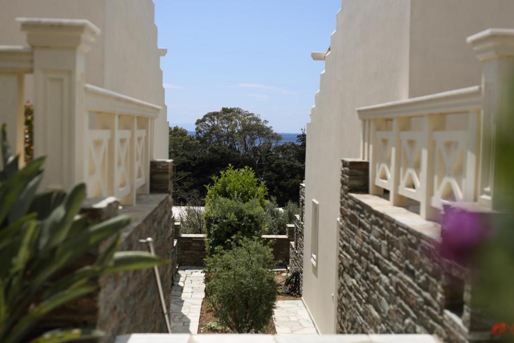 an external view of a house with a stone wall at Aithra -Agios Petros Andros in Gavrio