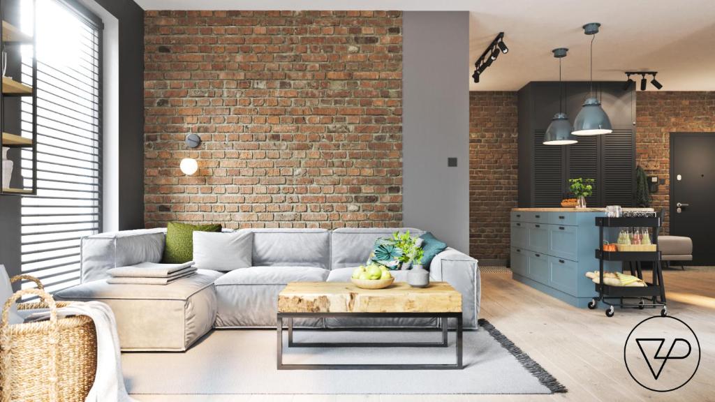 a living room with a couch and a brick wall at Apartament z widokiem na Zatokę Gdańską in Gdańsk