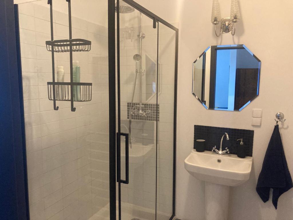 a bathroom with a shower and a sink at Apartament przy Aquaparku in Reda