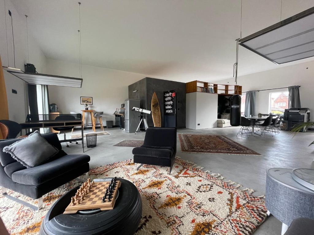 a living room with a chess board on a table at Holidayloft & Office in der alten Margarinefabrik in Bredstedt