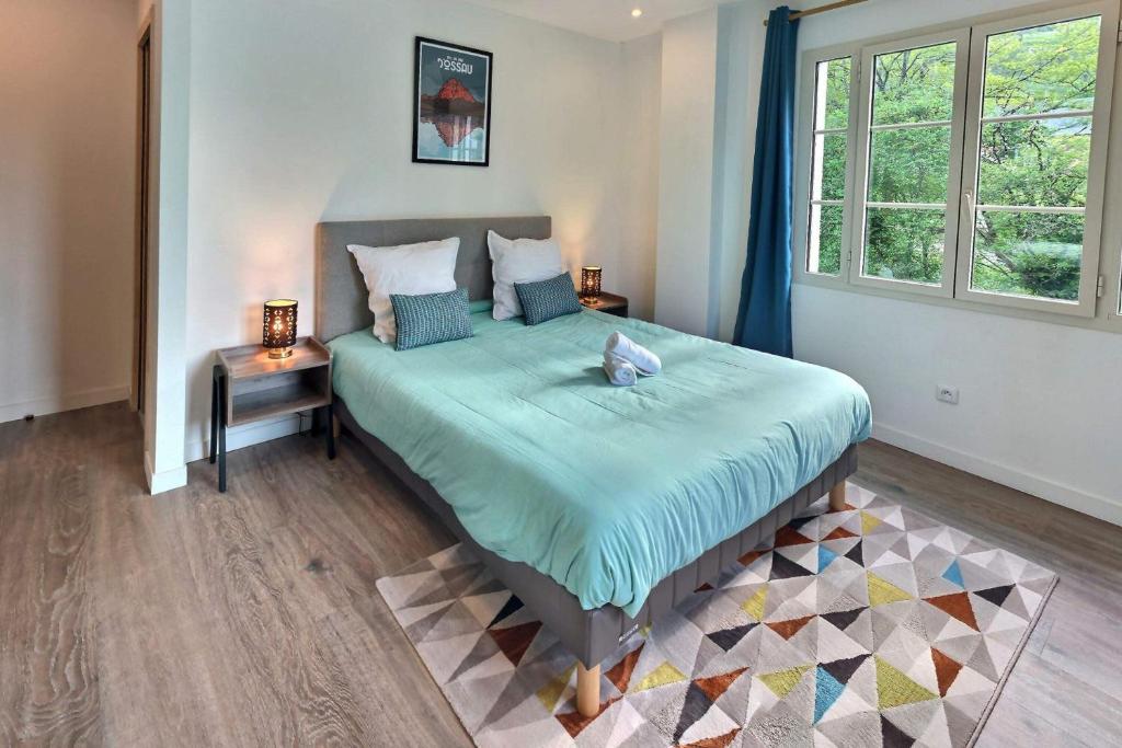 1 dormitorio con cama con sábanas azules y ventana en Superbe, T3 spacieux 78 m2, Neuf, Parking, en Gerde