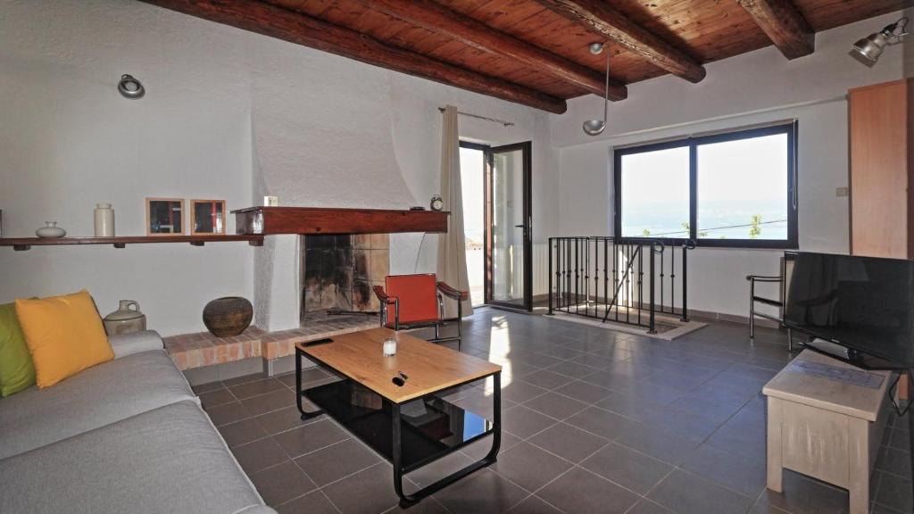 a living room with a couch and a fireplace at Two Olives in Vrbnik