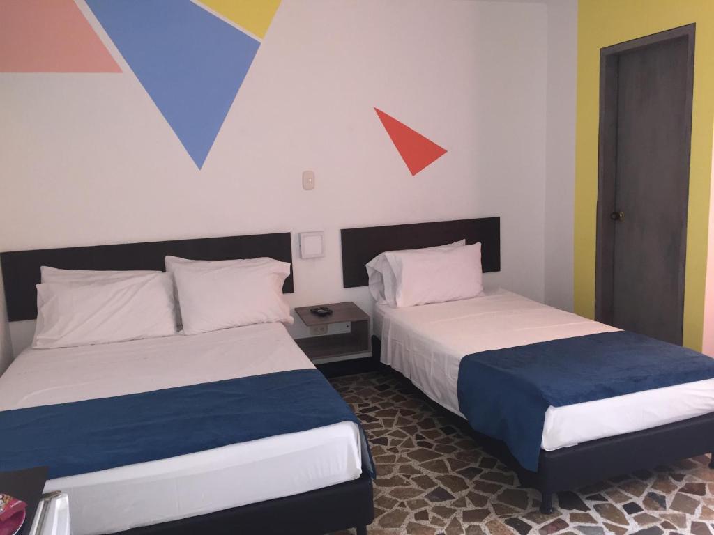 Postel nebo postele na pokoji v ubytování Hotel San Fermin Pereira
