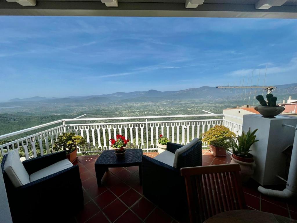 balkon z krzesłami i widokiem na góry w obiekcie Appartamento con Vista Panoramica w mieście Baunei