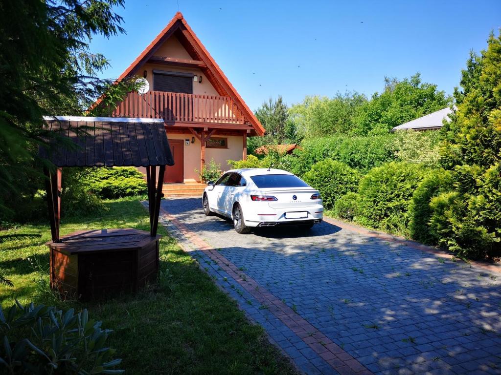 a white car parked in front of a house at Ustroń Dom Aneta in Ustroń