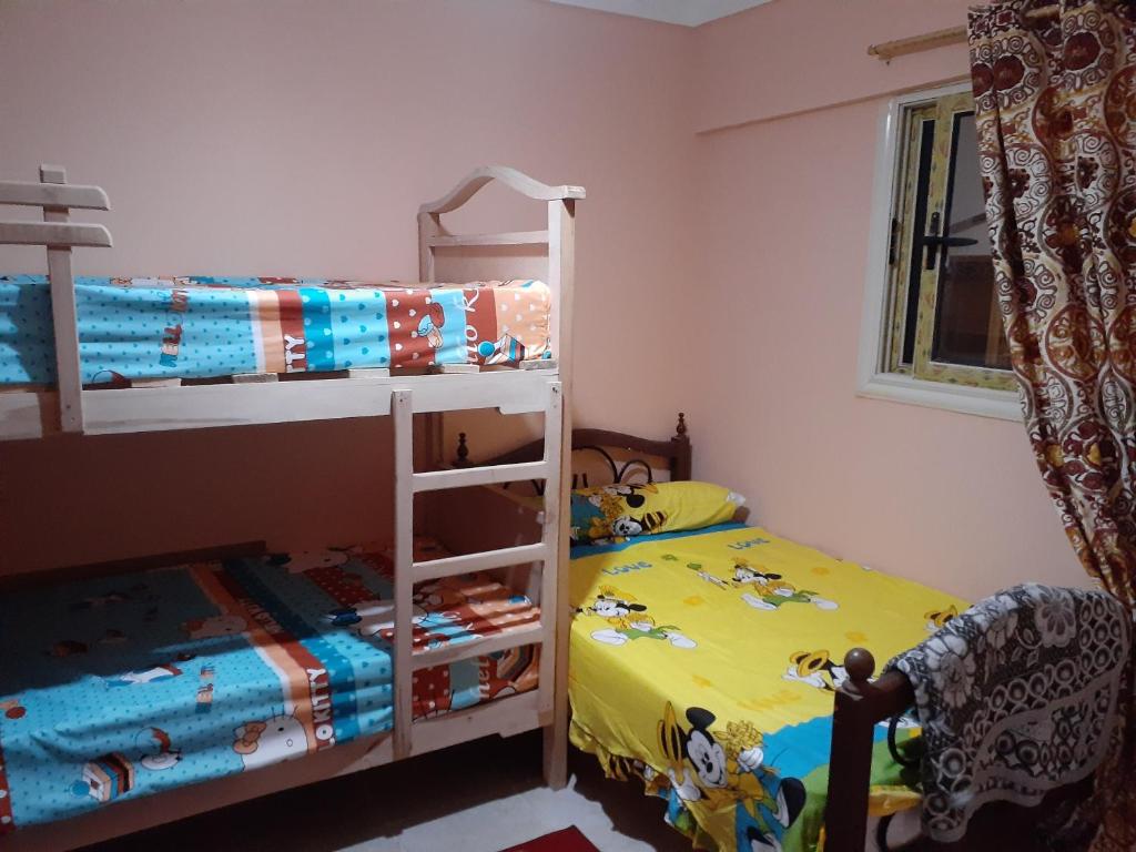 A bed or beds in a room at Free Wi-Fi شقة فندقية فى الاسكندرية New apartment sea view Alexandria