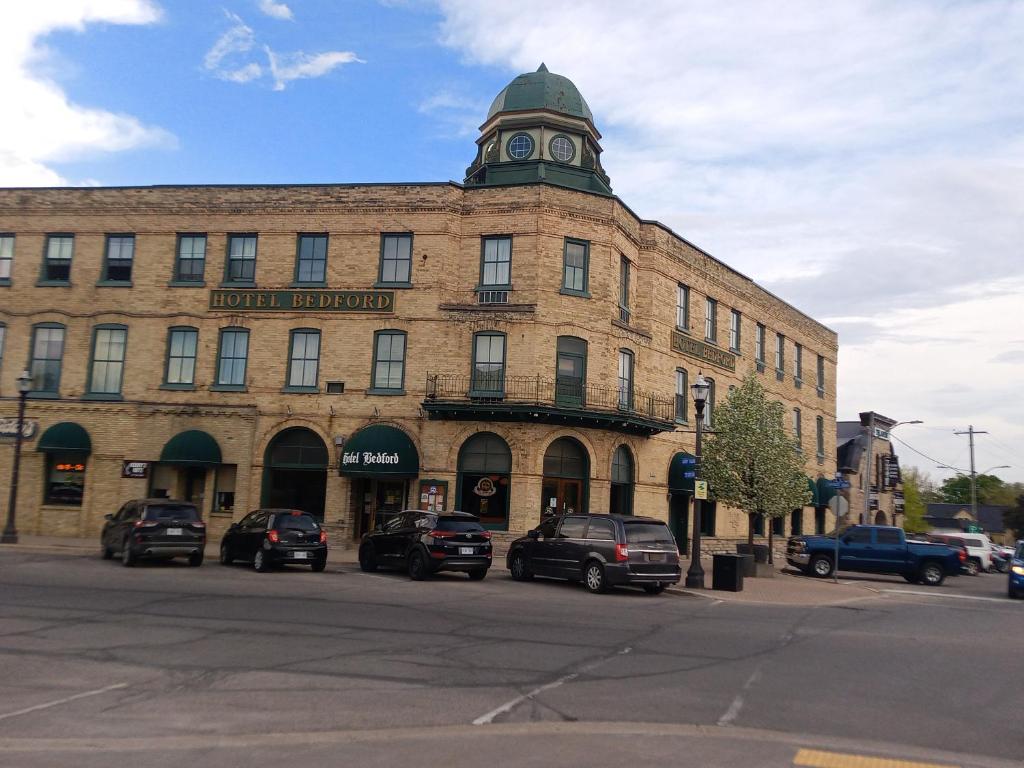 a large brick building with a clock tower on top of it at Hotel Bedford in Goderich