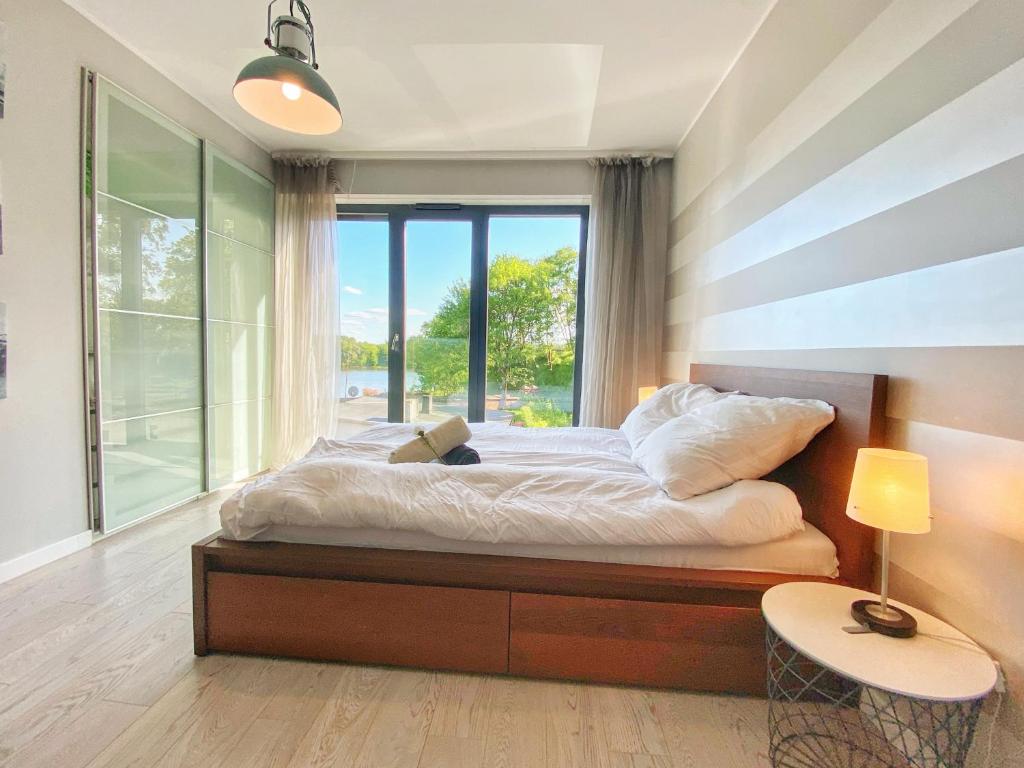 a bedroom with a bed with a large window at BP III Premium in Toruń