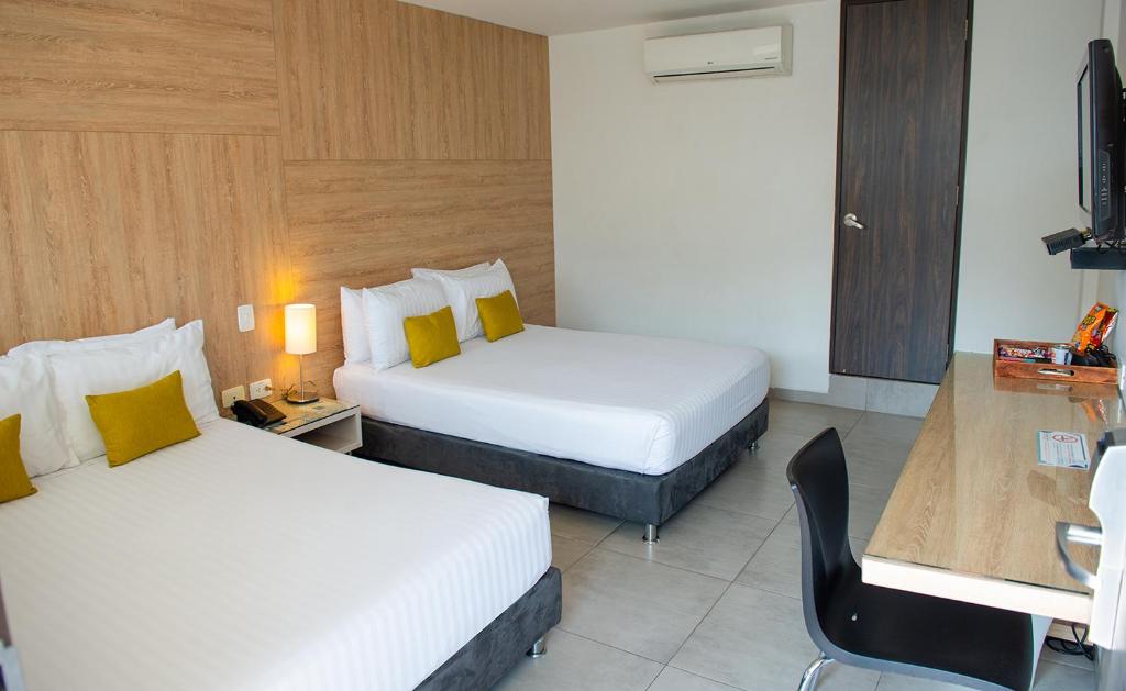 Postel nebo postele na pokoji v ubytování Hotel CasaBlanca Cucuta