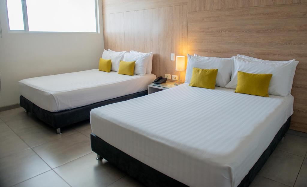 Postel nebo postele na pokoji v ubytování Hotel CasaBlanca Cucuta