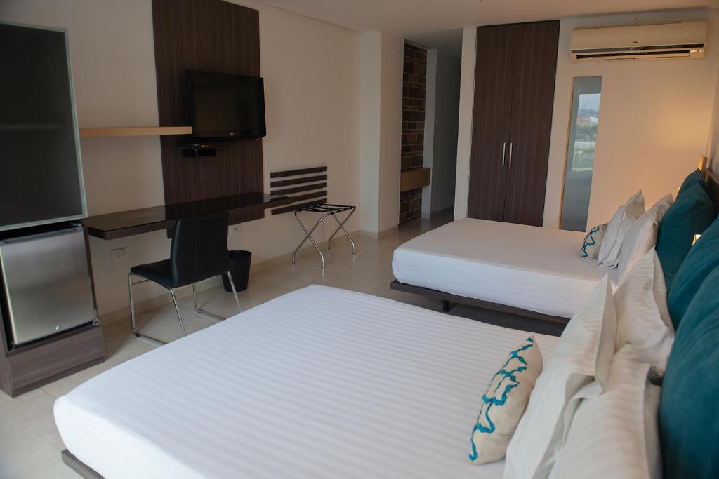 Postel nebo postele na pokoji v ubytování Hotel CasaBlanca Cucuta