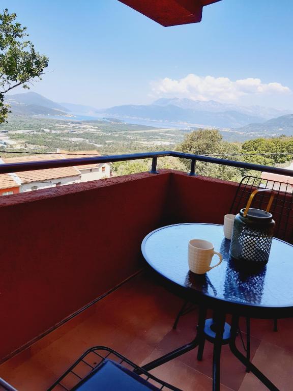 a table on a balcony with a view at Apartment Macic Dub II in Kotor