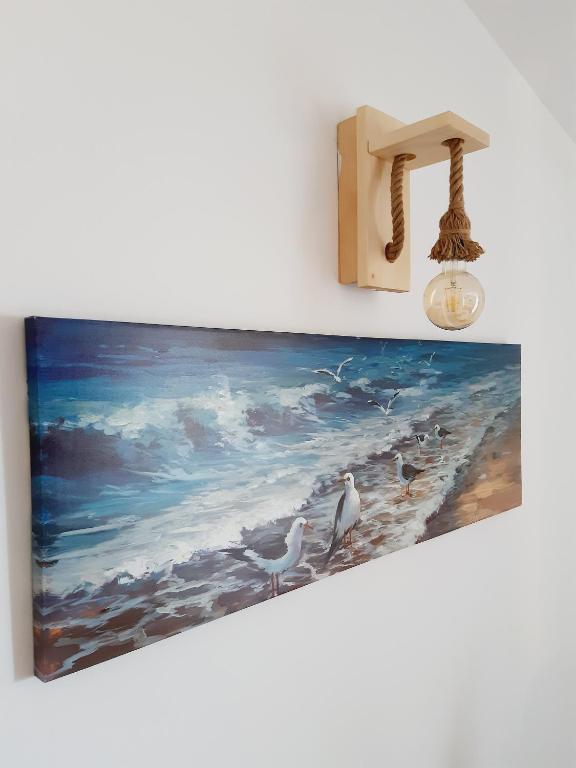a painting of seagulls on the beach at Apartment Macic Dub II in Kotor
